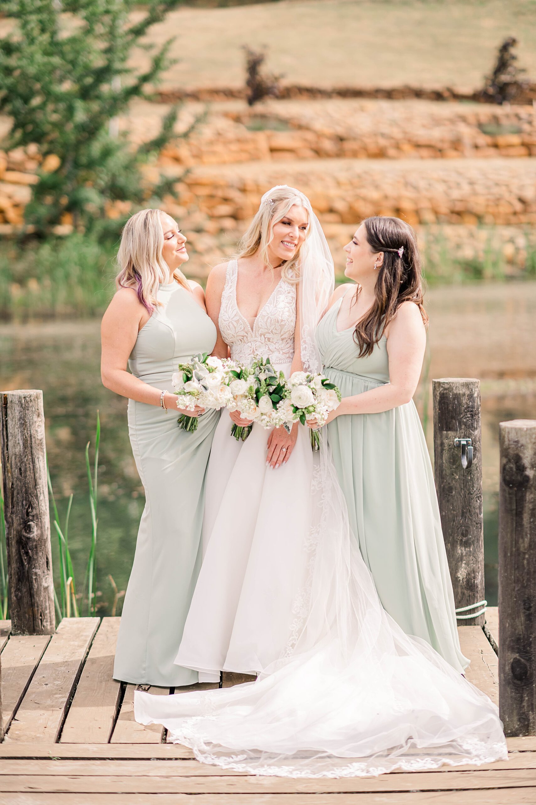 bride and bridesmaids on dock at Legacy Estate Vineyard  