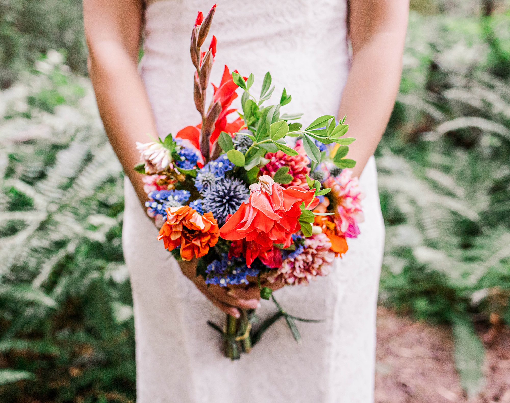 bride holds colorful wedding bouquet