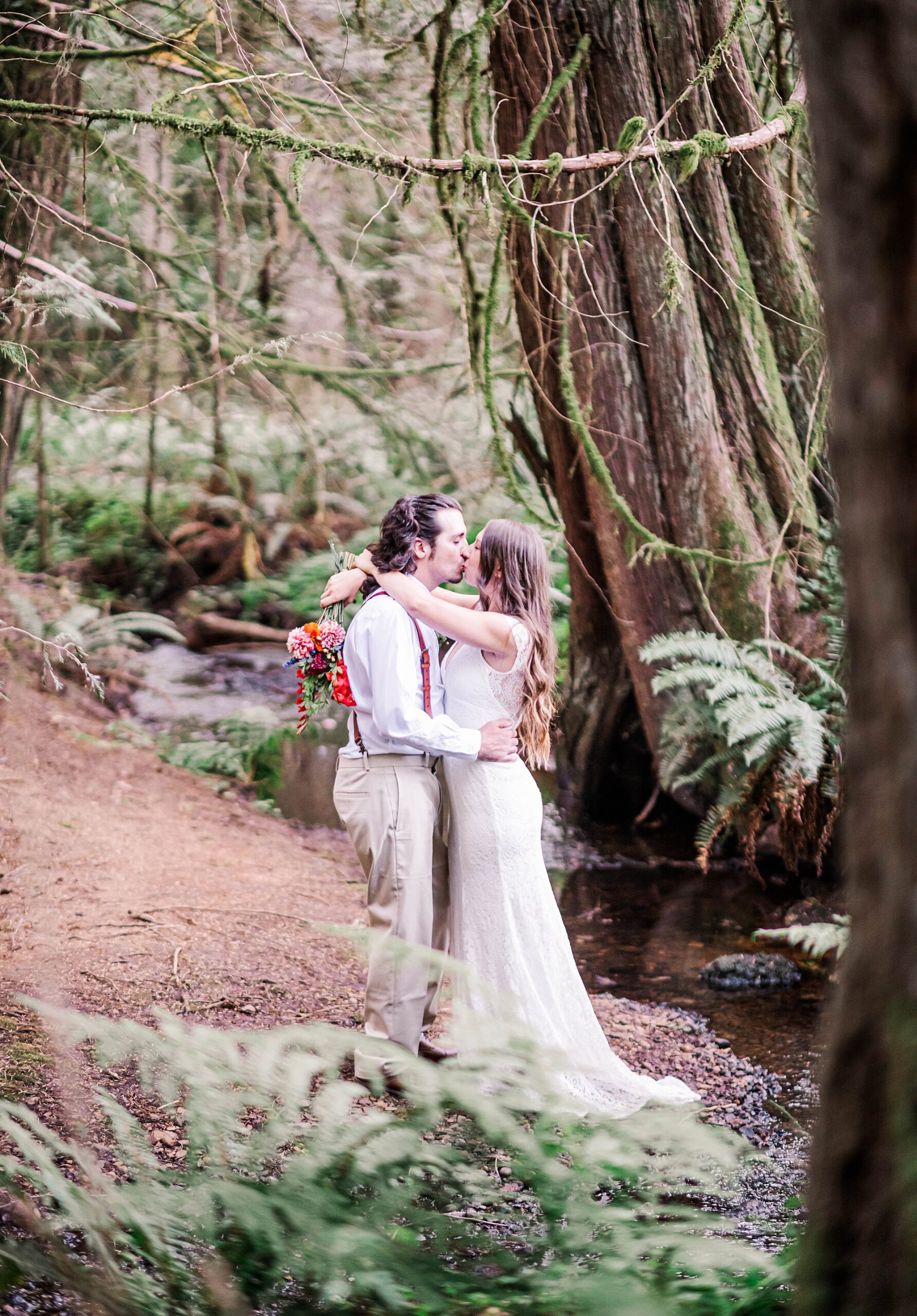 Newlyweds kiss in forest after ceremony