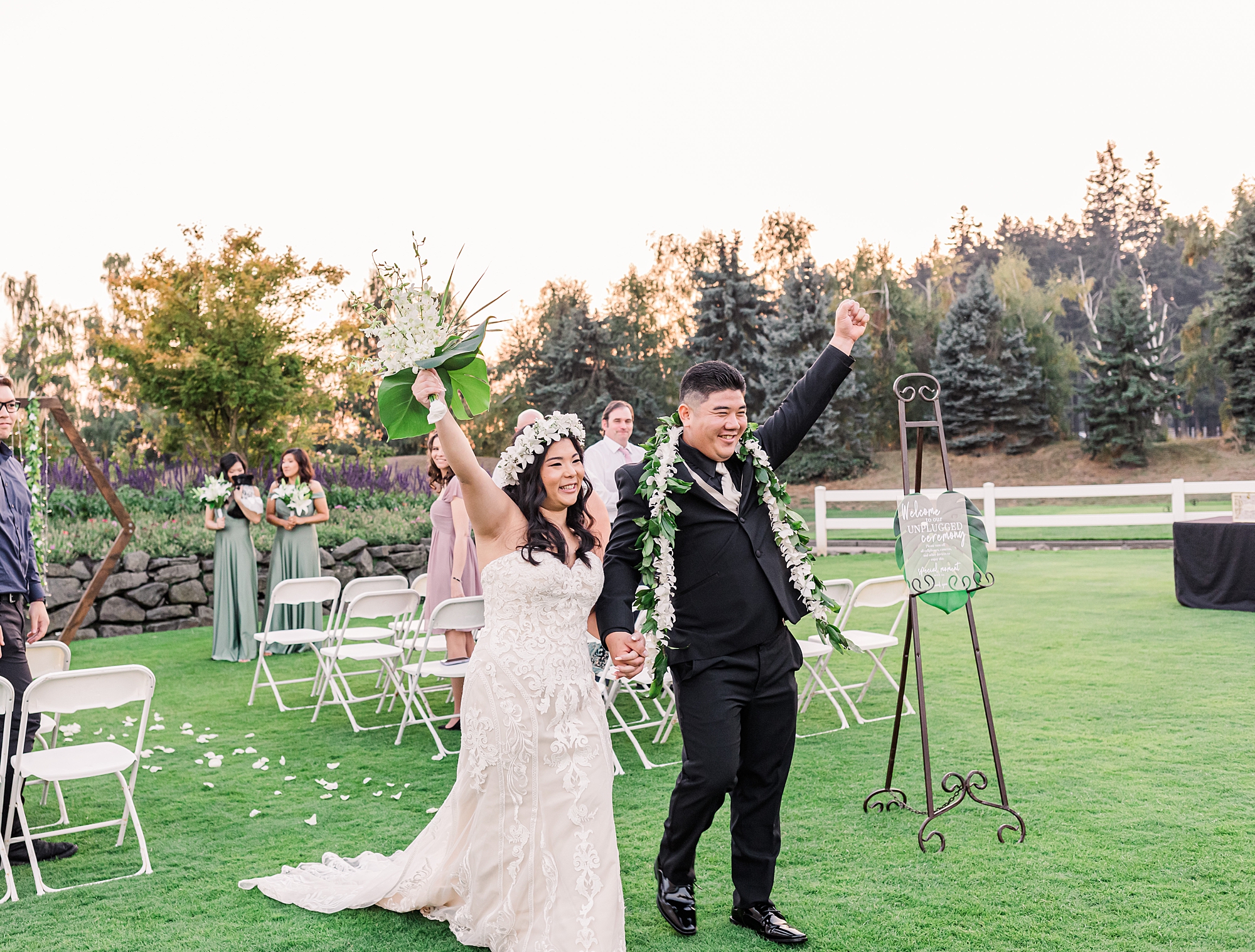 newlyweds celebrate as they exit wedding ceremony