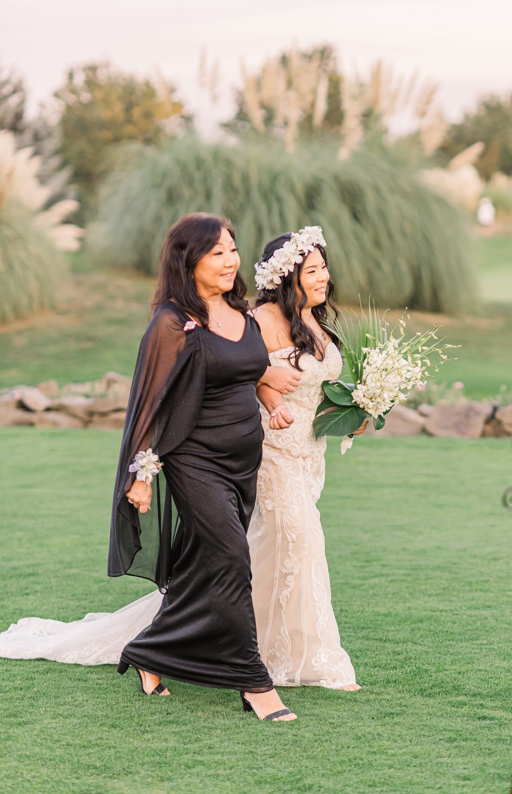 mother walks with daughter down the aisle 