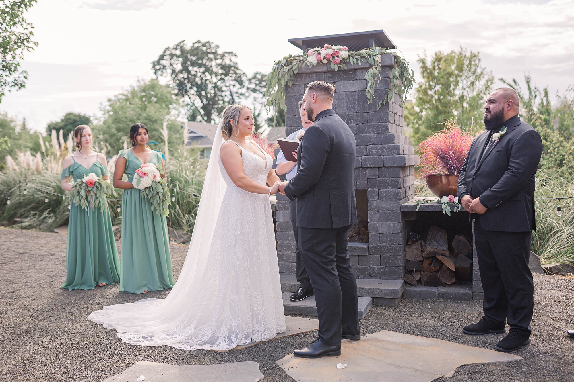 bride and groom exchange wedding vows during Intimate Backyard Oregon Wedding