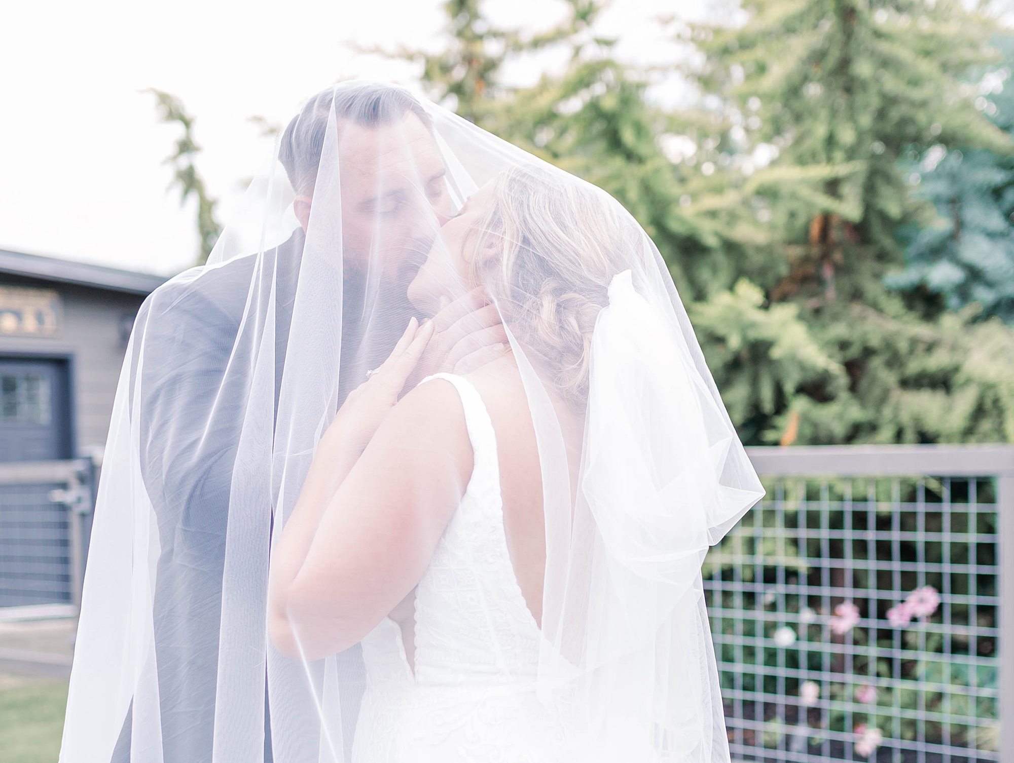 romantic newlywed portraits of couple under bride's veil
