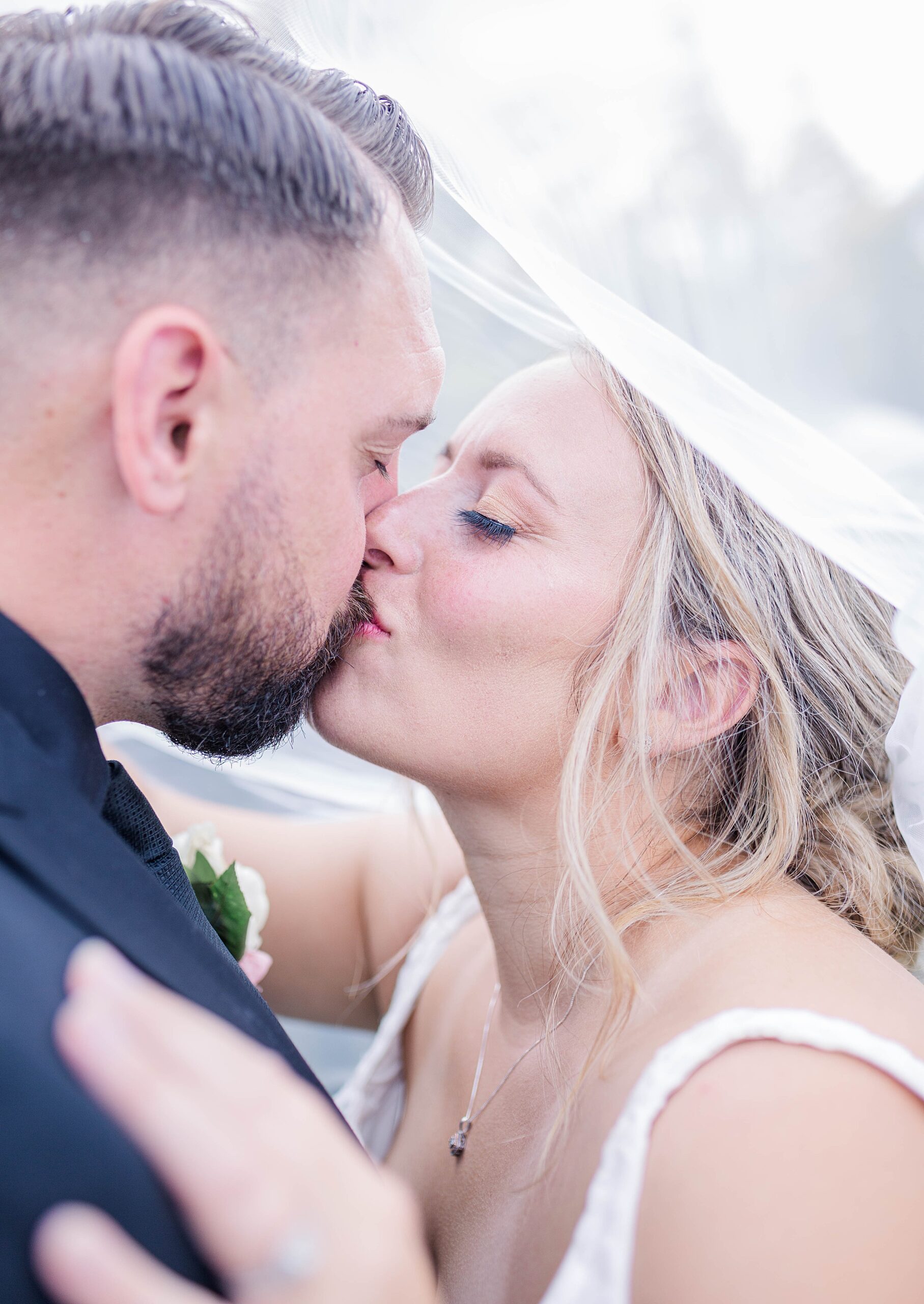 newlyweds kiss after Intimate Backyard Oregon Wedding