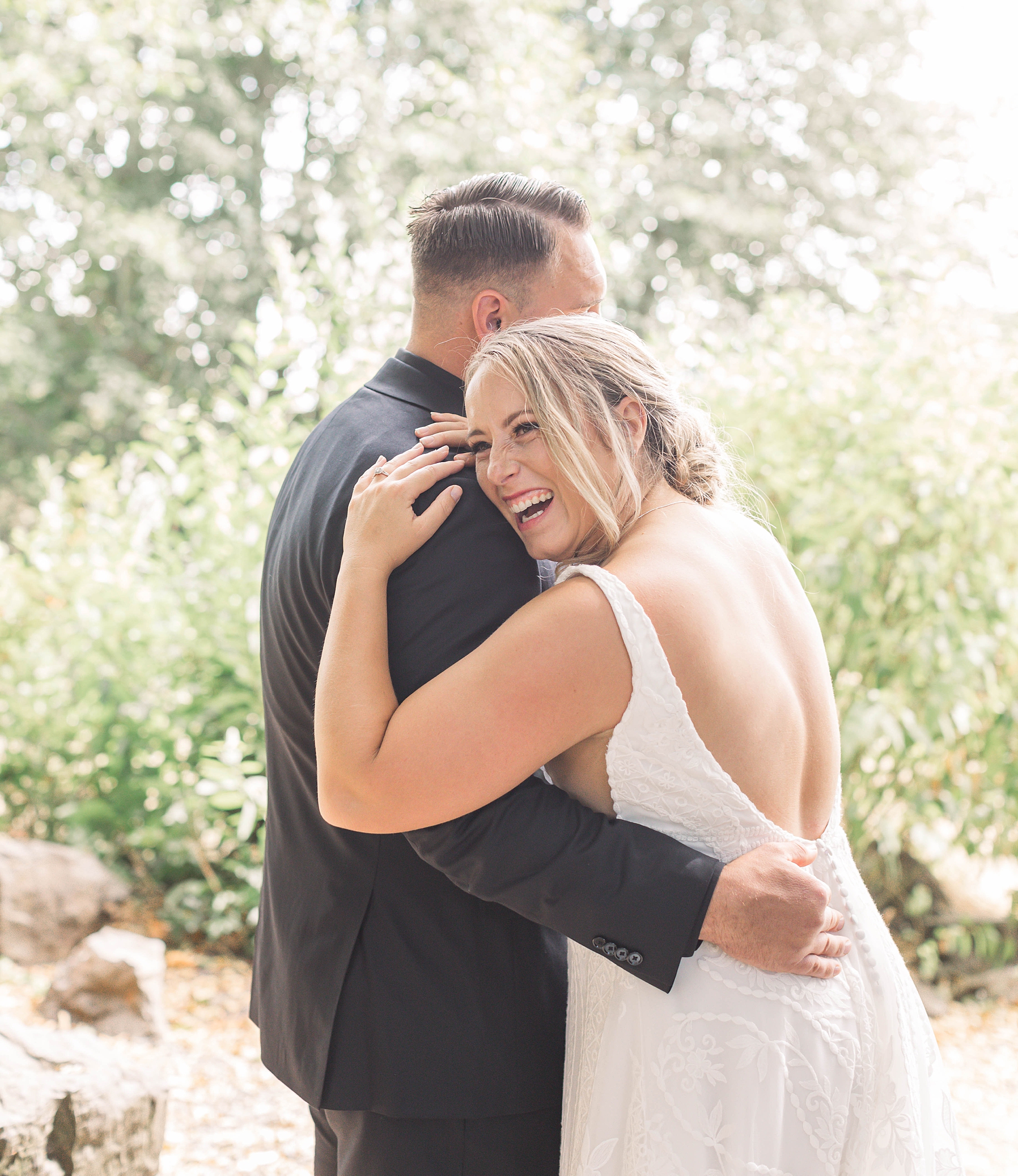 candid wedding photo of couple laughing 